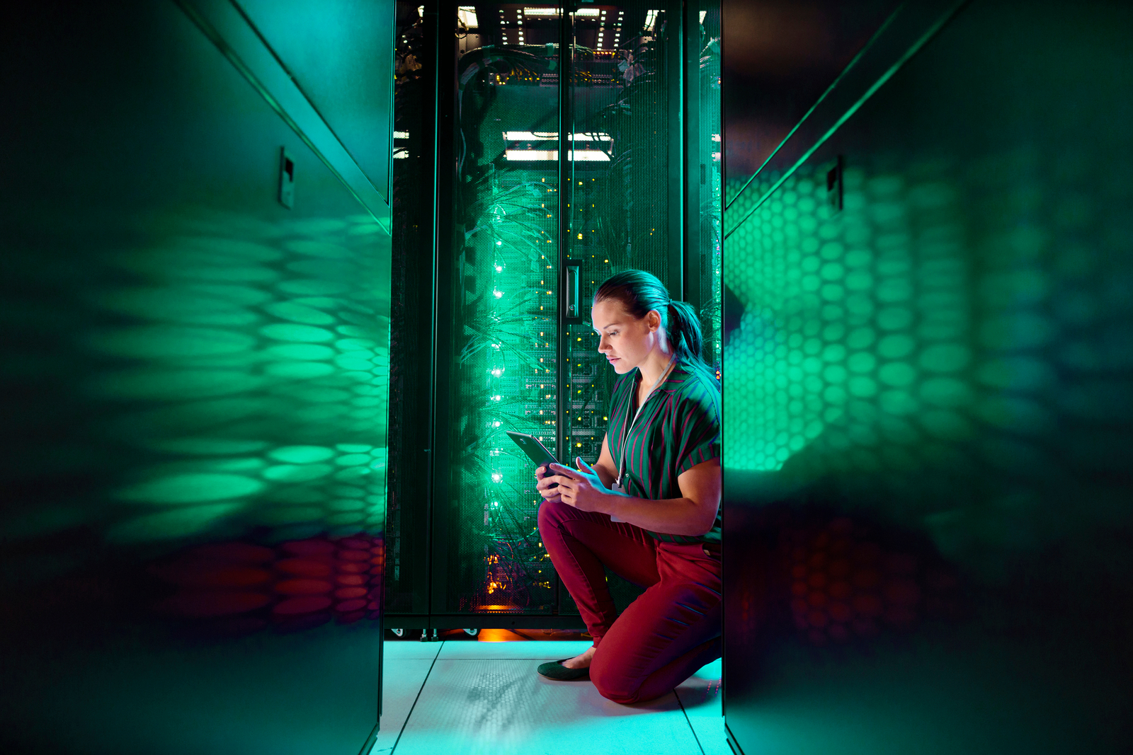 Woman with tablet in server room